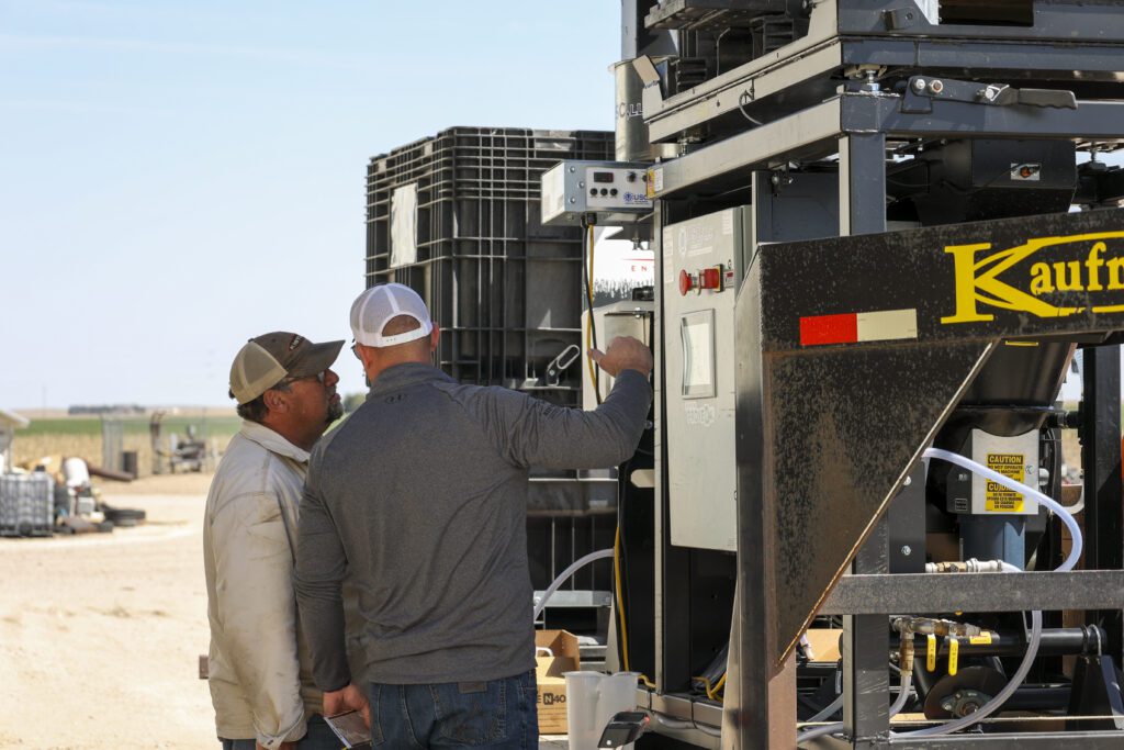 An image of a farmer and agribusiness consultant working on a farming plan together.