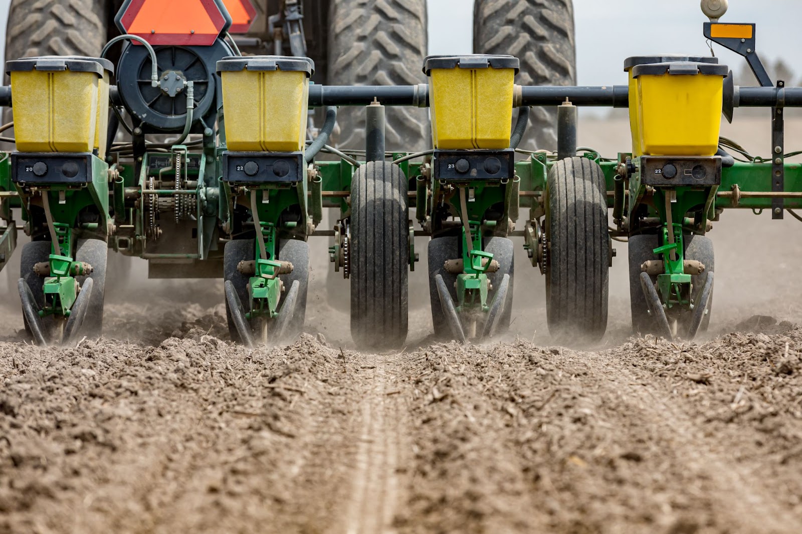 An image of a farmer preparing his field to plant the best hybrid seeds for the season.